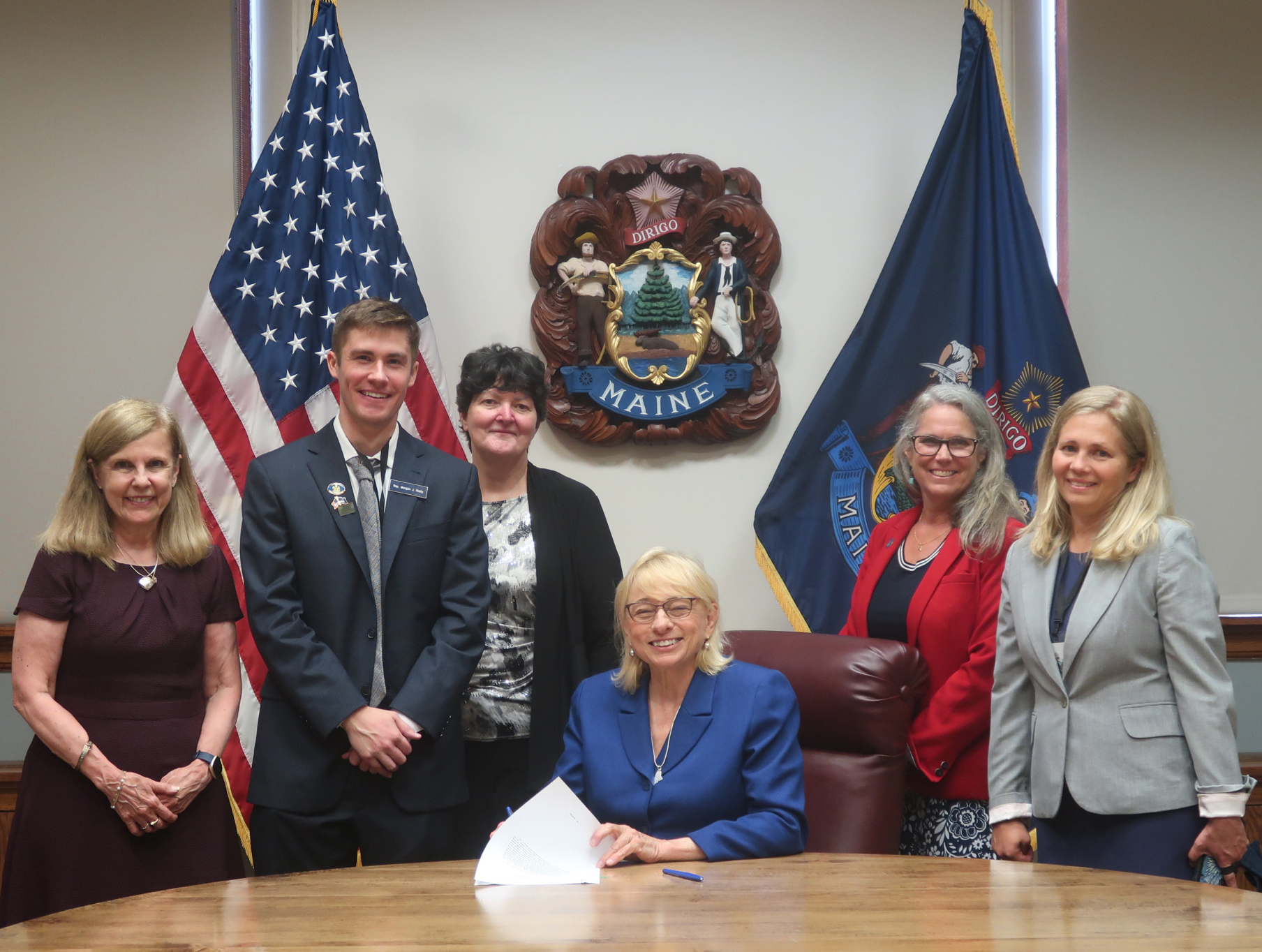 photo of elected officials in Maine signing legislation