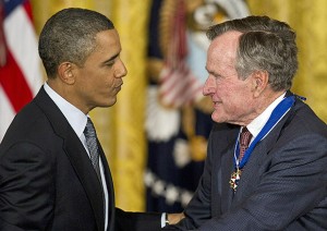 photo of Barak Obama and George HW Bush shaking hands