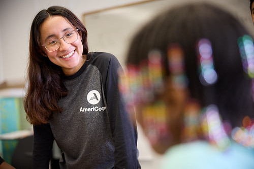 Person smiling with AmeriCorps tshirt